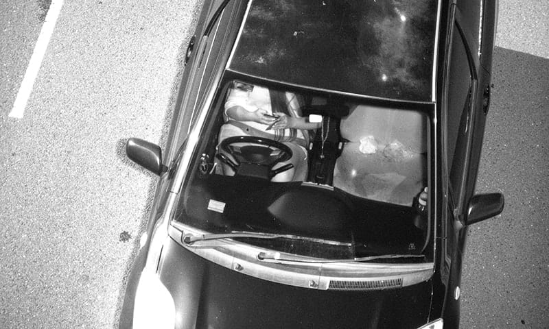 This Jan. 12, 2019, photo captured by a Mobile Phone Detection Camera and released by Transport for NSW shows a driver using a mobile phone while driving in Australia. Australian state New South Wales is attempting to persuade the public to put down their smartphones while driving by rolling out cameras to prosecute distracted motorists. New South Wales Roads Minister Andrew Constance said on Monday, Sept. 23, 2019, Australia’s most populous state was the first jurisdiction in the world to use such technology to punish drivers distracted by social media, text messages or phone calls. The government intends to roll out 45 Mobile Phone Detection Cameras across the state by December, he said. (Transport for NSW via AP)