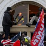 A mob of supporters of Donald Trump climbs through a window as they storm the US Capitol Building in Washington. Source: Reuters