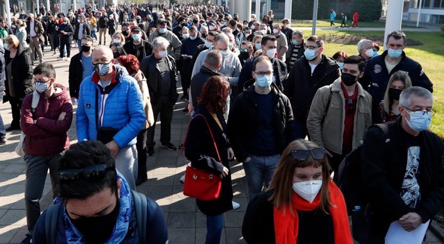 People wait to receive a dose of the AstraZeneca vaccine at Belgrade Fair makeshift vaccination centre in Belgrade, Serbia, Source: AP/ Al-Jazeera