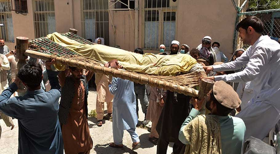 Relatives carry the body of a polio worker who was shot dead