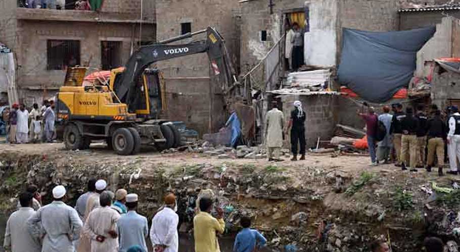 KDA staffers demolishing illegally constructed residences on Gujar Nullah