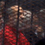 Muslim Brotherhood's senior member Mohamed El-Beltagi sits behind the bars during a court session. Source: Reuters