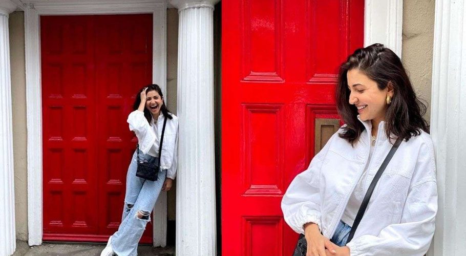The gorgeous Anushka Sharma is wearing a white t-shirt and blue ripped boyfriend jeans paired with a white jacket.