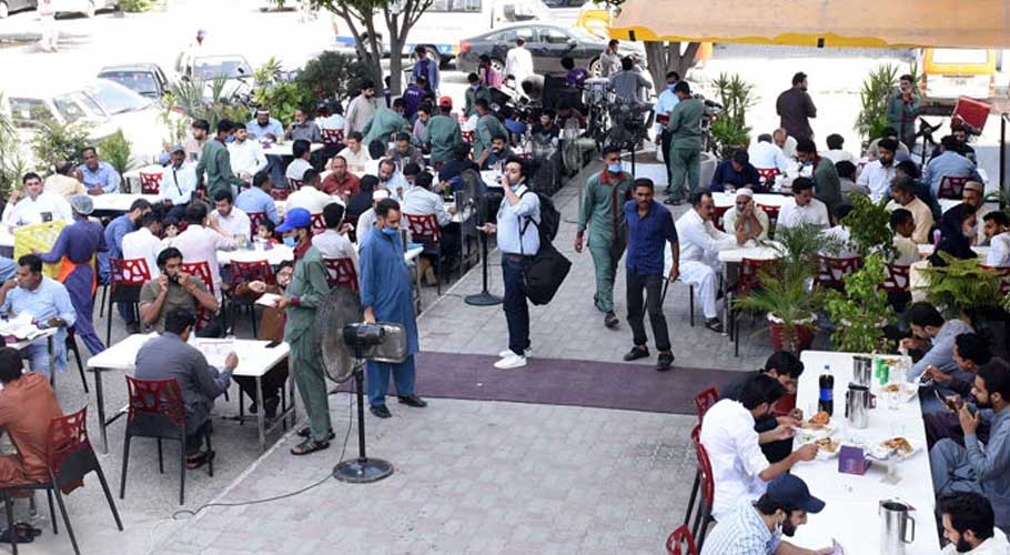 People can be seen at a restaurant at Blue Area in Islamabad,