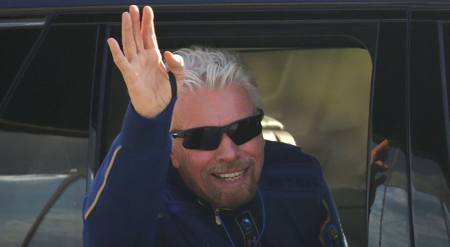 Billionaire entrepreneur Richard Branson departs with his crew prior to boarding, for travel to the edge of space in Virgin Galactic's passenger rocket plane VSS Unity. Source: Reuters
