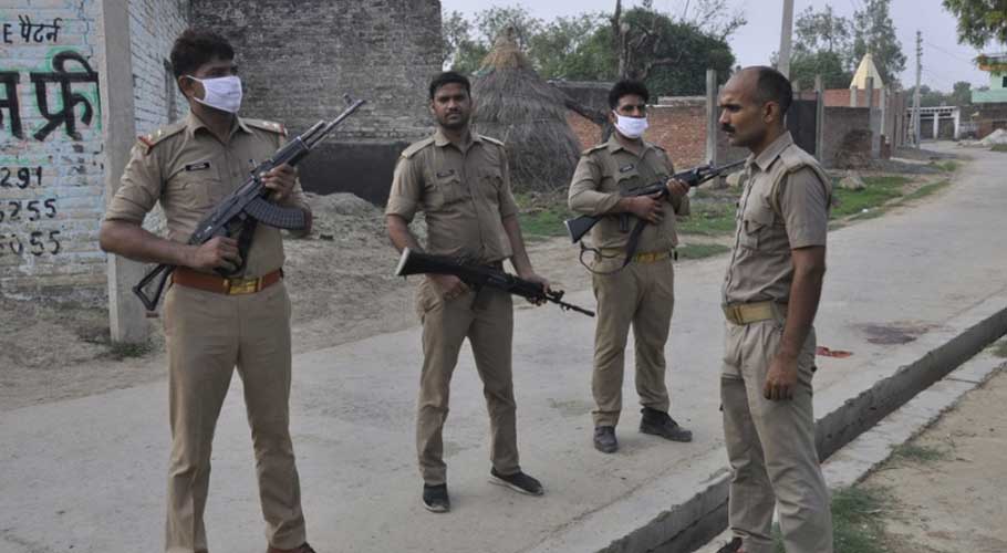 Policemen stand guard on a road in Kanpur. (Source: AP)