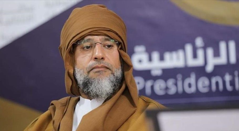 Saif al-Islam al-Gaddafi appeared in a traditional brown robe and turban with a grey beard and glasses. Source: Anadolu.