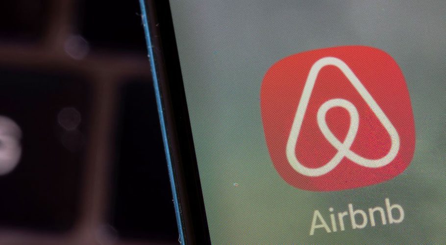 Airbnb app is seen on a smartphone in this illustration