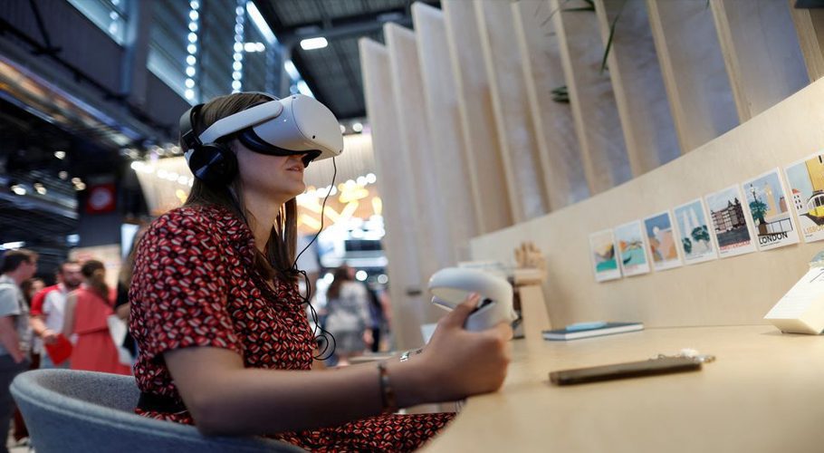 An attendee wearing a virtual reality (VR) headset tries out a VR application on the Meta Platforms Inc. booth at the Viva Technology conference dedicated to innovation and startups at Porte de Versailles exhibition center in Paris, France June 16, 2022. REUTERS/Benoit Tessier/File Photo