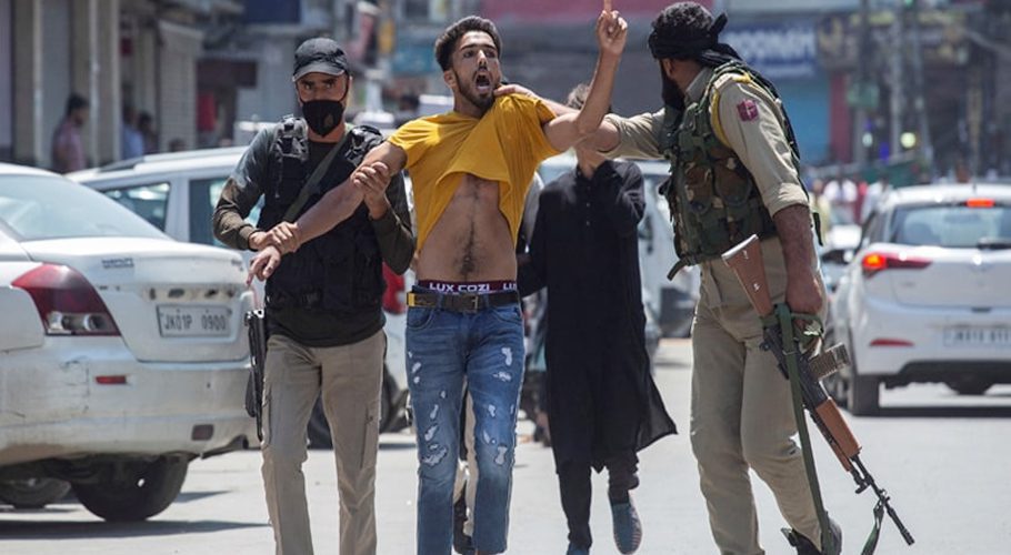 In this file photo, taken on August 17, 2021, Indian policemen detain a Kashmiri Muslim as devotees defy restrictions for a Muharram procession in Srinagar. — AFP/File