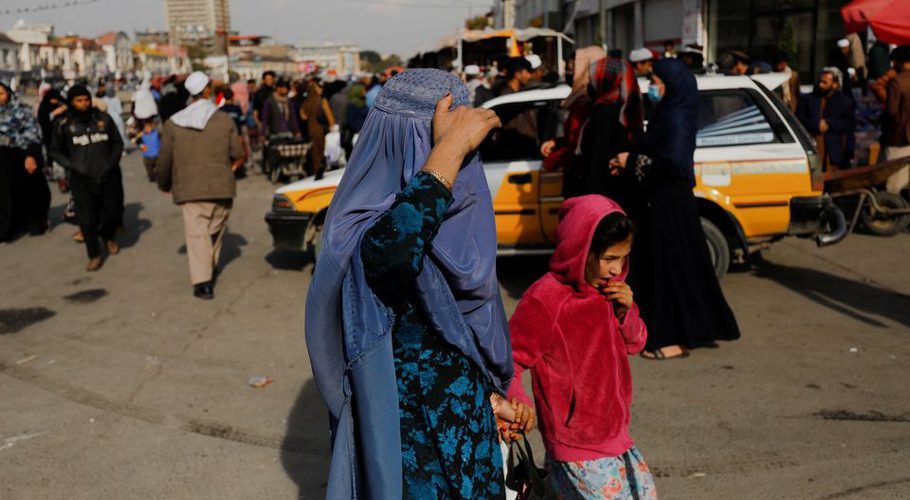 An Afghan woman and a girl walk in a street in Kabul, Afghanistan, November 9, 2022. REUTERS/Ali Khara