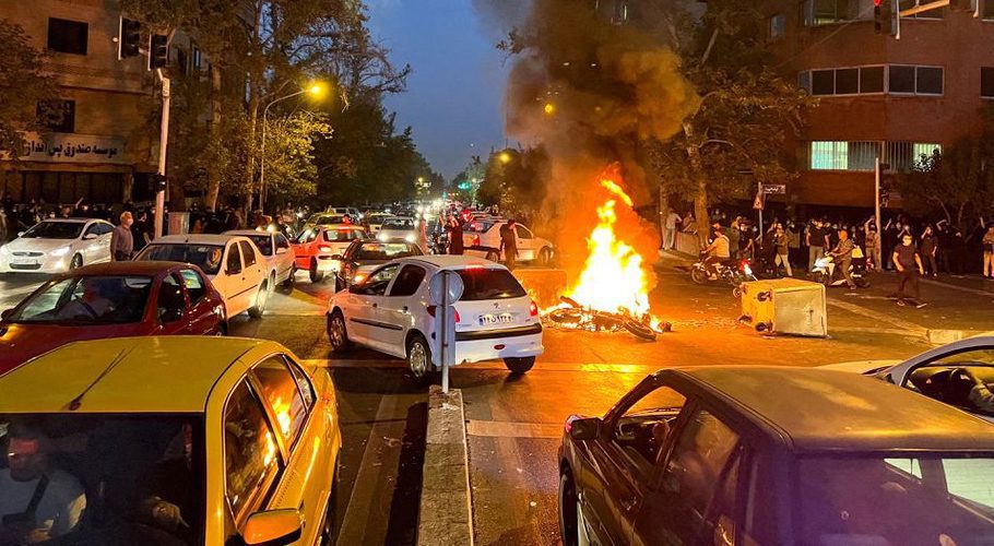 A police motorcycle burns during a protest over the death of Mahsa Amini, a woman who died after being arrested by the Islamic republic's "morality police", in Tehran, Iran September 19, 2022. WANA (West Asia News Agency) via REUTERS