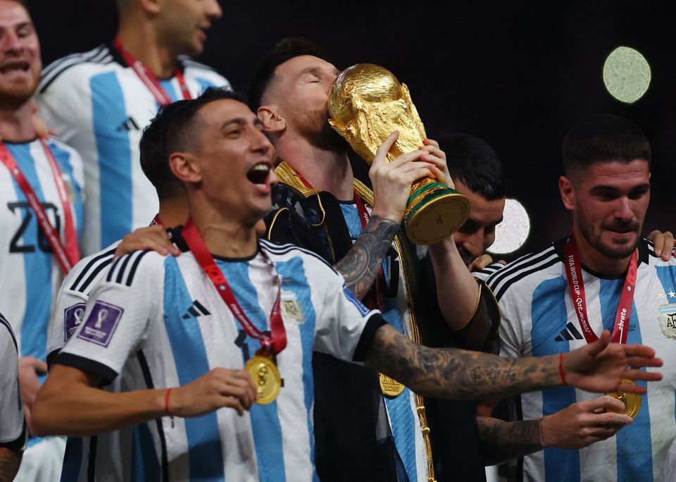 FIFA World Cup Qatar 2022 - Final - Argentina v France - Lusail Stadium, Lusail, Qatar - December 18, 2022 Argentina's Lionel Messi kisses the trophy as he celebrates winning the World Cup REUTERS/Hannah Mckay