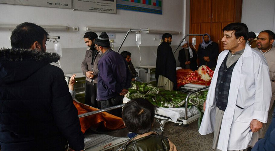 Relatives visit Afghan men receiving treatment at a hospital after they were wounded when a roadside bomb hit a bus carrying employees of a petroleum company in Mazar-i- Sharif on December 6, 2022. — AFP