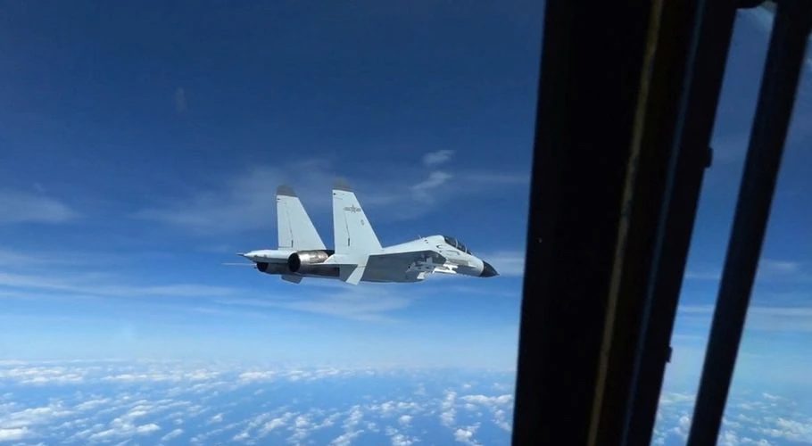 A Chinese Navy J-11 fighter jet is recorded flying close to a U.S. Air Force RC-135 aircraft in international airspace over the South China Sea, according to the U.S. military, in a still image from video taken December 21, 2022. U.S. Indo-Pacific Command/Handout via REUTERS.