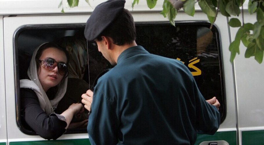 In this file photo taken on July 23, 2007, an Iranian policeman speaks with a woman sitting in a police car after she was arrested because of her “inappropriate” clothes during a crackdown to enforce Islamic dress code in the capital Tehran. — AFP