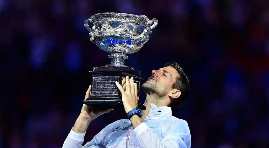 Novak Djokovic celebrates with the Australian Open trophy following his victory against Stefanos Tsitsipas. Photograph: Manan Vatsyayana/AFP/Getty Images