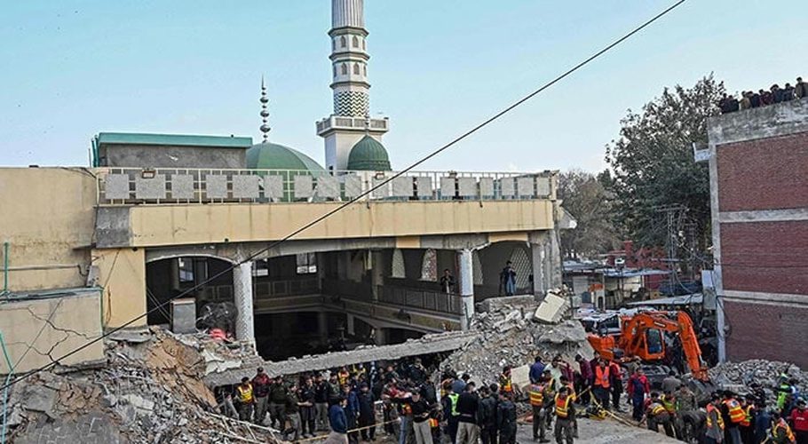 Security personnel and rescue workers prepare to search for the blast victims in the debris of a damaged mosque inside the police headquarters in Peshawar on January 30, 2023. — AFP