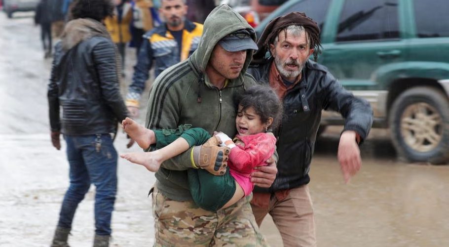 A man carries a girl following an earthquake, in rebel-held town of Jandaris, Syria February 6, 2023. REUTERS/Khalil Ashawi