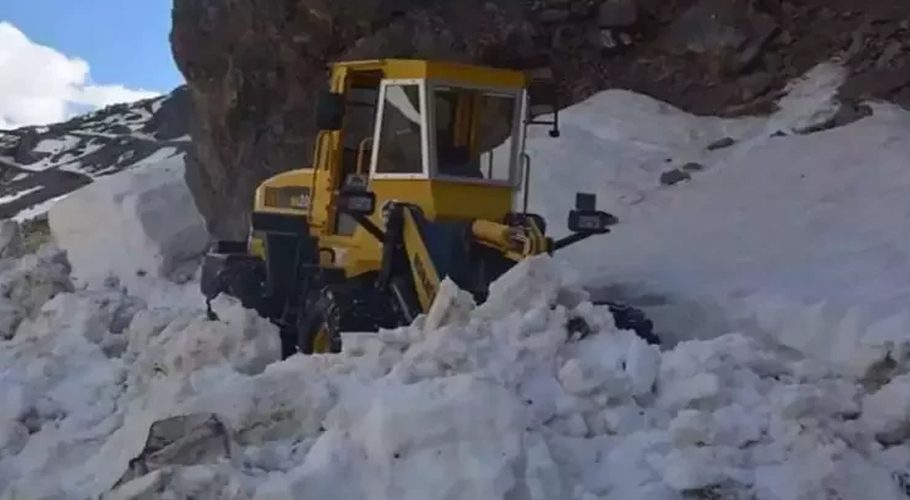A file photo shows that an excavator clears the road in the Astore district of Gilgit Baltistan.