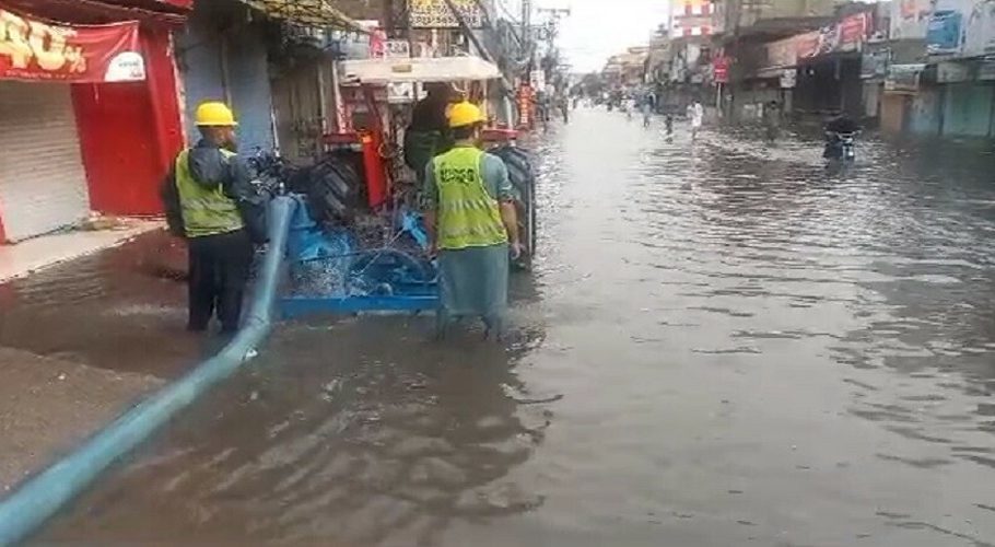 Local authorities drain rainwater at a street in Rawalpindi on Saturday. — Photo Dawn.com