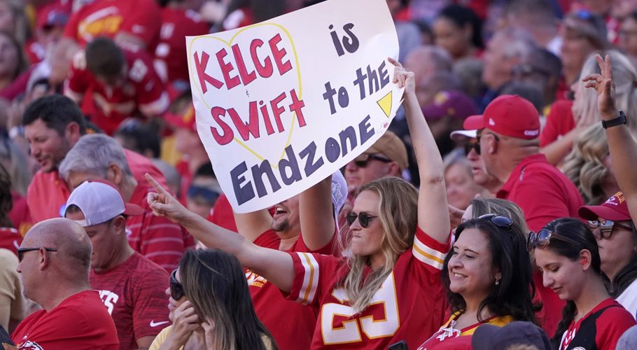 A fan holds a sign in support of Taylor Swift and Travis Kelce. Ed Zurga/AP