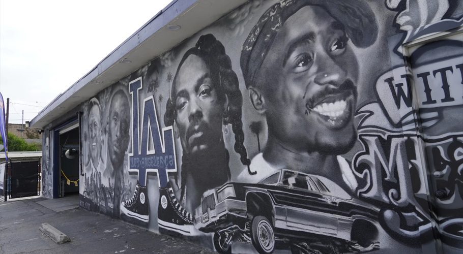 A portion of a mural by artist sloe_motions depicting Oscar De La Hoya, Vin Scully, Kobe Bryant, Snoop Dogg and Tupac Shakur adorns the side of Speedy Auto Tint on Friday in Bellflower, Calif.

    Chris Pizzello/The Associated Press