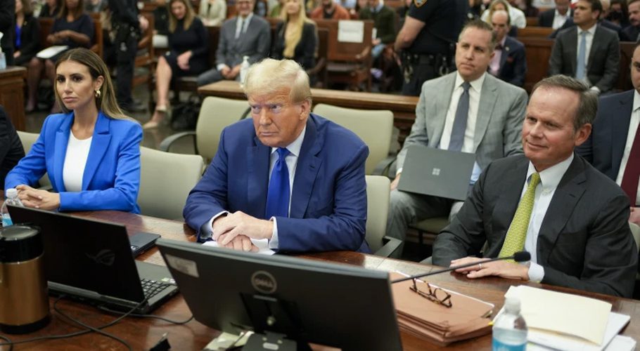 FILE - Former President Donald Trump, center, flanked by his defense attorneys, Alina Habba, left, and Chris Kiss, waits for the continuation of his civil business fraud trial at New York Supreme Court, Oct. 25, 2023, in New York. (AP Photo/Seth Wenig, Pool)