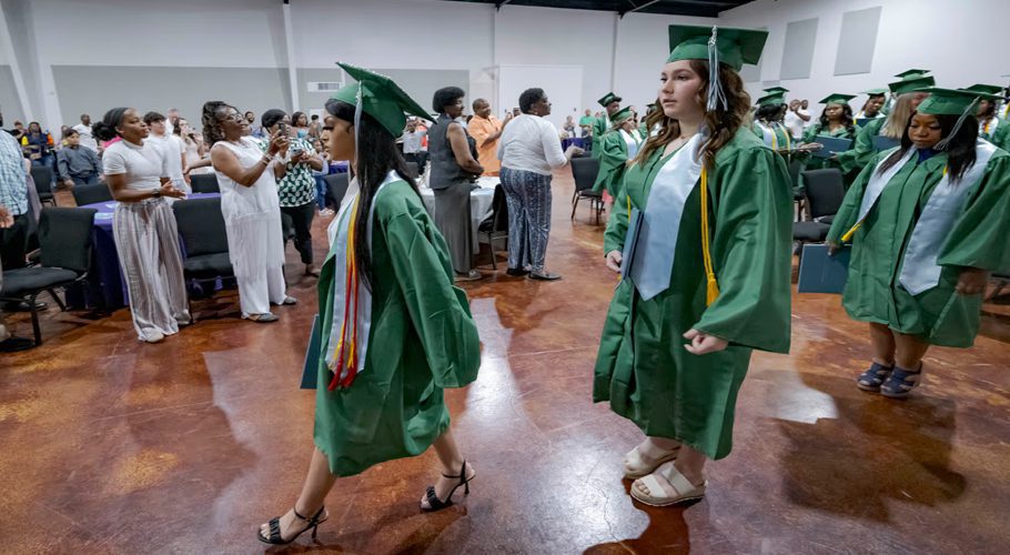Salutatorian Alasia Baker, 17, center, and Khyli Barbee, 15, lead a line of graduates awarded diplomas by Springfield Prep.