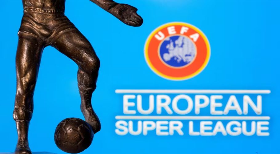 A metal figure of a football player with a ball is seen in front of the words "European Super League" and the UEFA logo in this illustration taken April 20, 2021. REUTERS/Dado Ruvic/Illustration/File Photo Acquire Licensing Rights