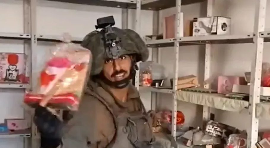 An Israeli soldier has made a video that shows him vandalising a Palestinian-owned shop in Gaza and mocking its contents. (Screengrab)