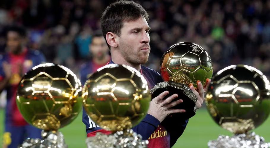 Barcelona's football player Lionel Messi poses with his four Ballon d'Or (Golden Ball) trophies before their Spanish King's Cup soccer match against Malaga at Nou Camp Stadium in Barcelona January 16, 2013. REUTERS/ Albert Gea/File Photo