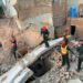 Rescue 1122 workers can be seen performing a rescue operation at the site of the collapsed building. — Photo Dawn.com