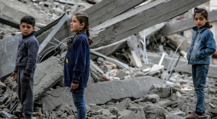 Palestinian children look at the rubble of a building destroyed in an Israeli strike on Gaza City. Photo: AFP