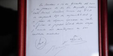 FILE - A framed copy of the napkin linking the 13-year-old Lionel Messi to FC Barcelona is seen in Barcelona, Spain on Jan. 5, 2012. British auction house Bonhams says the famous napkin that linked a young Lionel Messi to Barcelona has sold for $965,000. An agreement in principle to sign then 13-year-old Messi was written on the napkin almost 25 years ago at a Barcelona tennis club. (AP Photo/Manu Fernandez, File)