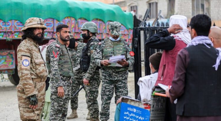 Pakistan's border police check the papers of Afghan people before they cross into Pakistan at the zero point Torkham border crossing between Afghanistan and Pakistan, in Nangarhar province, Feb. 25, 2023. (AFP)
