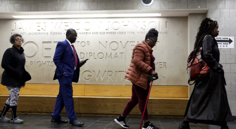 People walk to vote in the 2024 presidential election on Election Day in New York City, New York, U.S., November 5, 2024. REUTERS/Kent J. Edwards