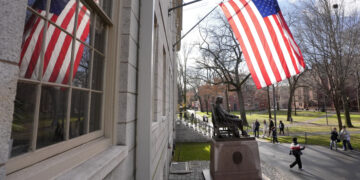 People walk past the John Harvard statue in Harvard Yard, Tuesday, Dec. 17, 2024, on the campus of Harvard University in Cambridge, Mass. (AP Photo/Steven Senne)