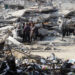 FILE/ Palestinians stand among the rubble of houses destroyed in previous Israeli strikes, amid ceasefire negotiations with Israel, in Gaza City, January 15, 2025. REUTERS/Mahmoud Issa