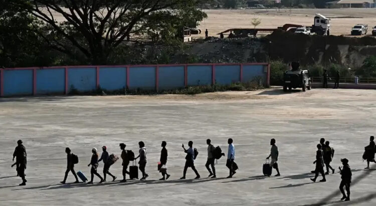 Alleged victims of scam centres in Kyaukhat town in Myanmar’s Kayin State walk in line as they are met by the Thai Army after crossing the Thai-Myanmar border. AFP