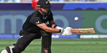 New Zealand’s Daryl Mitchell plays a shot during the ICC Champions Trophy one-day international (ODI) final cricket match between India and New Zealand at the Dubai International Stadium in Dubai on March 9, 2025. (Photo by FADEL SENNA / AFP)