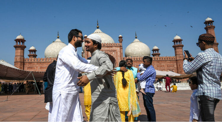 Muslims hug eachother after offering Eid al-Fitr prayers at the Badshahi Mosque in Lahore on May 24, 2020. (AFP/File)