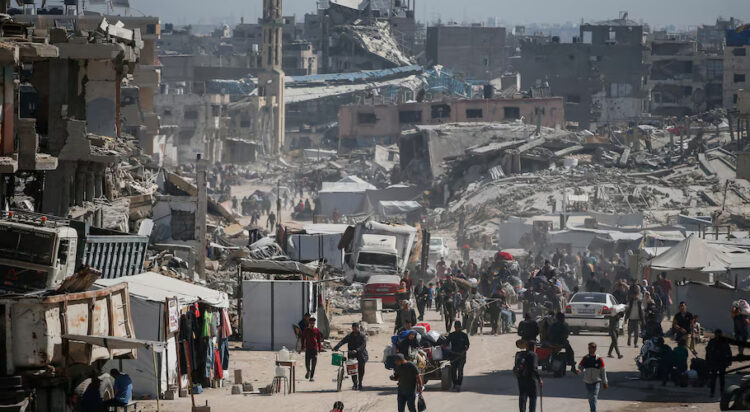 Palestinians make their way with belongings as they fled their homes, after Israeli air strikes, in the northern Gaza Strip May 16, 2025. REUTERS/Mahmoud Issa