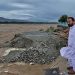 File/ Local residents at the Swat River, which is overflowing due to pre-monsoon heavy rains in the area on the outskirts of Mingora, the main town of Pakistan's Swat Valley [Sherin Zada/AP]
