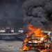 A car burns on Atlantic Boulevard during a standoff by protesters and law enforcement, following multiple detentions by Immigration and Customs Enforcement (ICE), in the Los Angeles County city of Paramount, California, U.S., June 7, 2025. REUTERS/Barbara Davidson