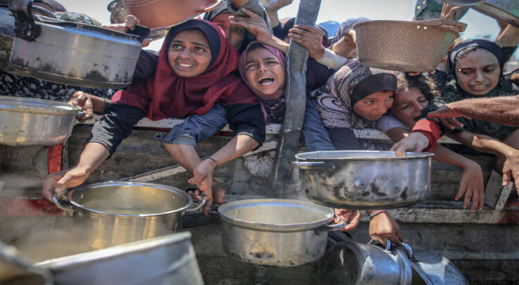 People wait to receive hot meals in Gaza this month. Photograph: Anadolu/Getty Images