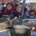 People wait to receive hot meals in Gaza this month. Photograph: Anadolu/Getty Images