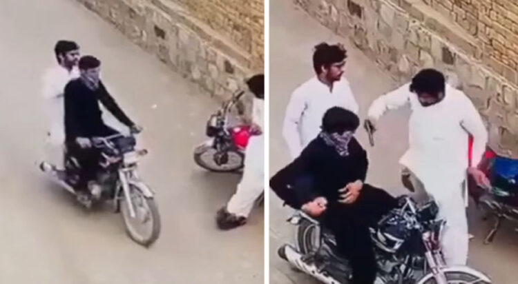 The video shows two men in black and white clothing arriving on a motorcycle. They approach a man in the street, slap him, and demand his valuables. (Screengrab)