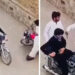 The video shows two men in black and white clothing arriving on a motorcycle. They approach a man in the street, slap him, and demand his valuables. (Screengrab)
