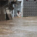 A resident navigates through a flooded street in a neighbourhood of Mingora, the main town in the Swat Valley. Photograph: Naveed Ali/AP